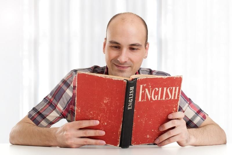 man reading English learning book