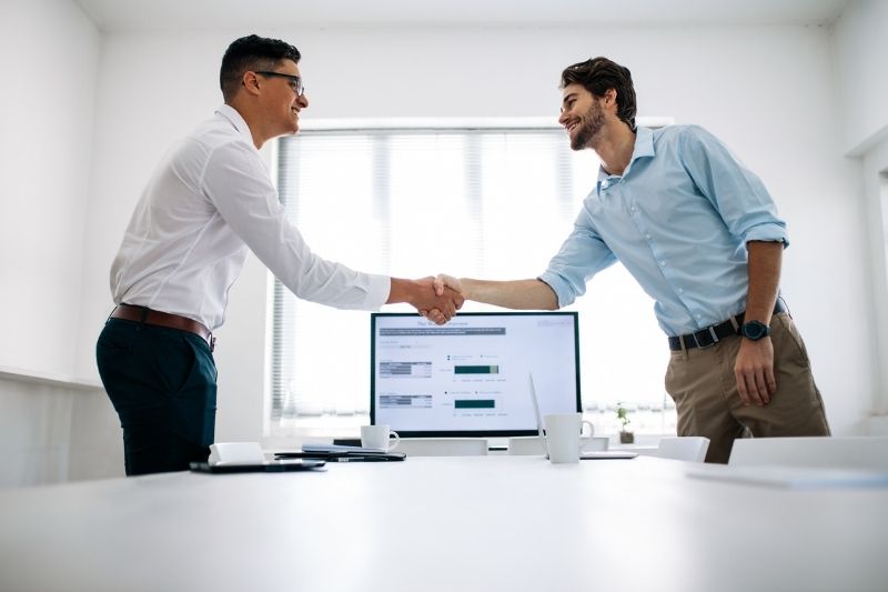 two adults hand shake